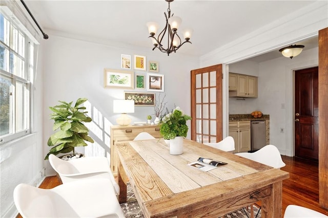 dining space with a wealth of natural light, a chandelier, and hardwood / wood-style flooring