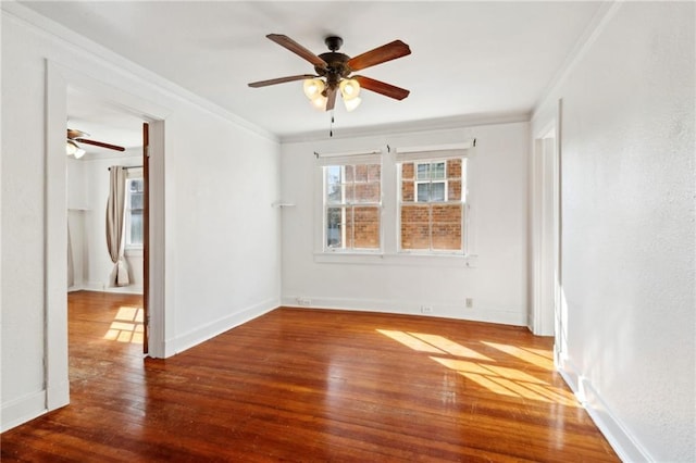 empty room featuring hardwood / wood-style flooring, ceiling fan, and ornamental molding