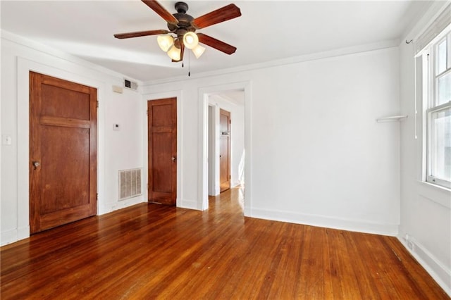 spare room featuring wood-type flooring and ceiling fan