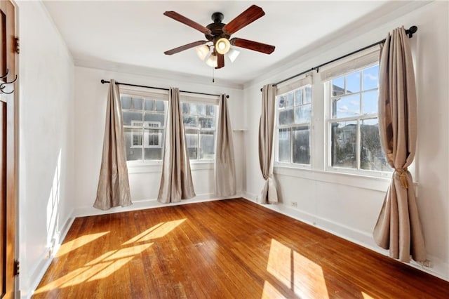 unfurnished room with hardwood / wood-style flooring and ceiling fan