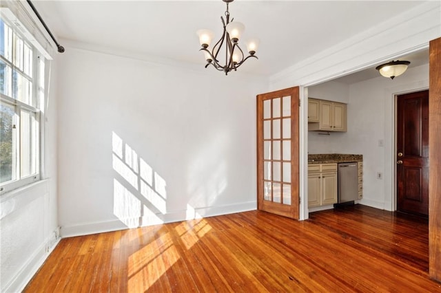 unfurnished dining area with hardwood / wood-style flooring and a notable chandelier