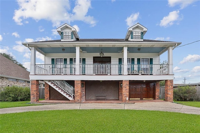 view of front of house with a porch, a garage, and a front lawn