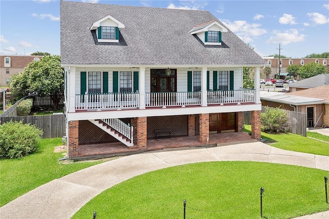 cape cod house with a front yard, a porch, and a garage