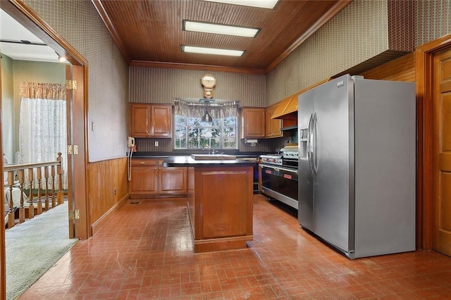 kitchen with a kitchen island, crown molding, stainless steel appliances, and wooden walls