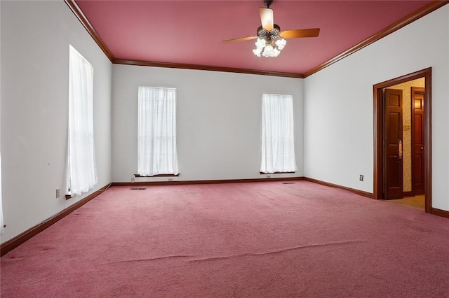 spare room with a healthy amount of sunlight, light colored carpet, ceiling fan, and ornamental molding