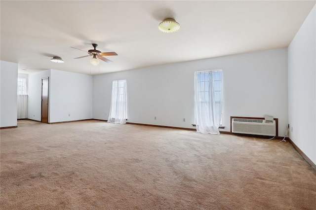 unfurnished room featuring a wall mounted air conditioner, carpet flooring, and ceiling fan