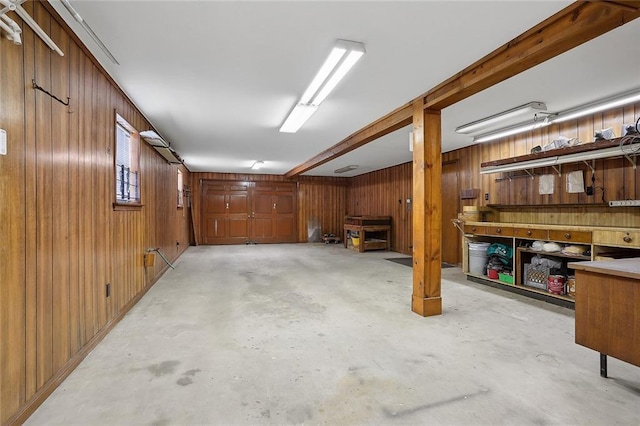 basement featuring a workshop area and wood walls