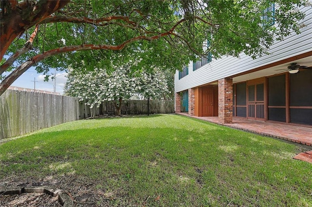 view of yard featuring a patio and ceiling fan