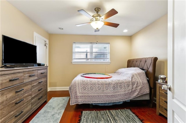 bedroom with ceiling fan and dark wood-type flooring