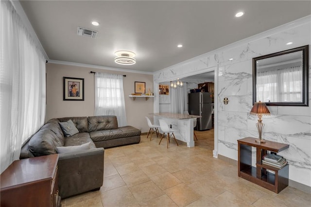 living room with crown molding and tile walls