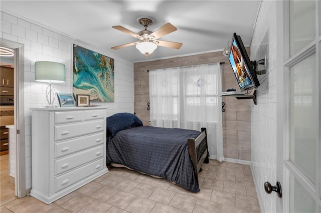 tiled bedroom featuring ceiling fan and crown molding