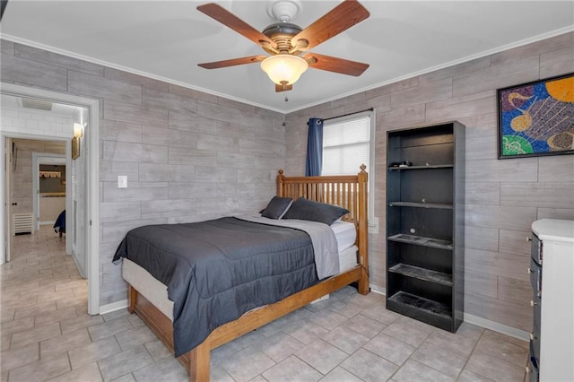 bedroom featuring ceiling fan, crown molding, and tile walls