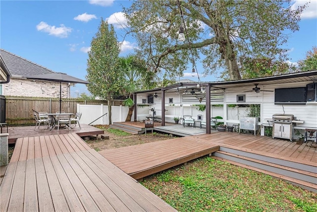 wooden deck featuring a pergola, area for grilling, and ceiling fan