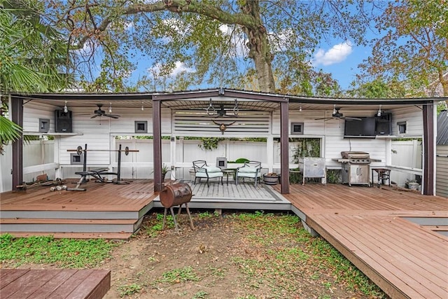 deck featuring area for grilling and ceiling fan