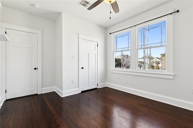 unfurnished bedroom featuring ceiling fan and dark wood-type flooring