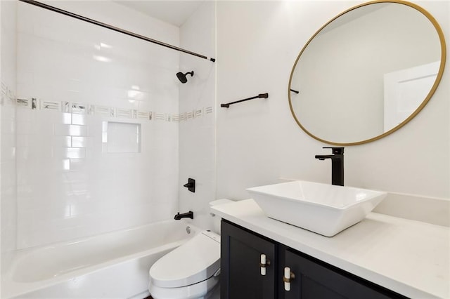 full bathroom featuring toilet, vanity, and tiled shower / bath