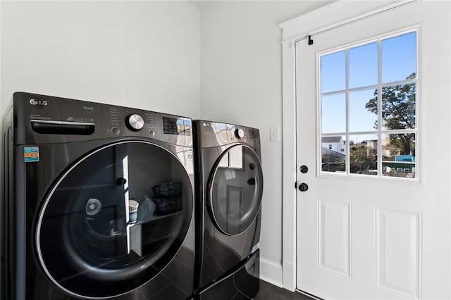 laundry room featuring a healthy amount of sunlight and independent washer and dryer