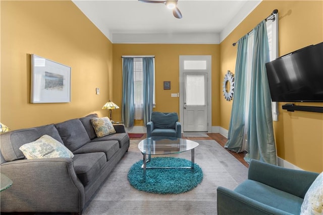 living room with light hardwood / wood-style floors and ceiling fan