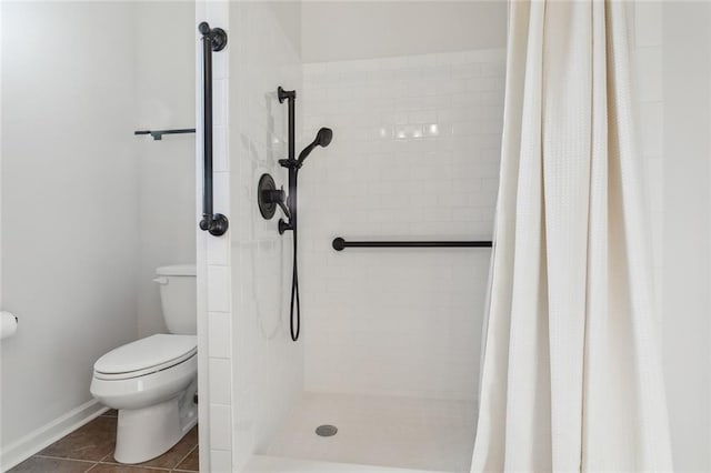 bathroom with a shower with curtain, toilet, and tile patterned floors