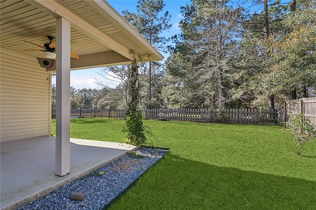 view of yard with ceiling fan and a patio area