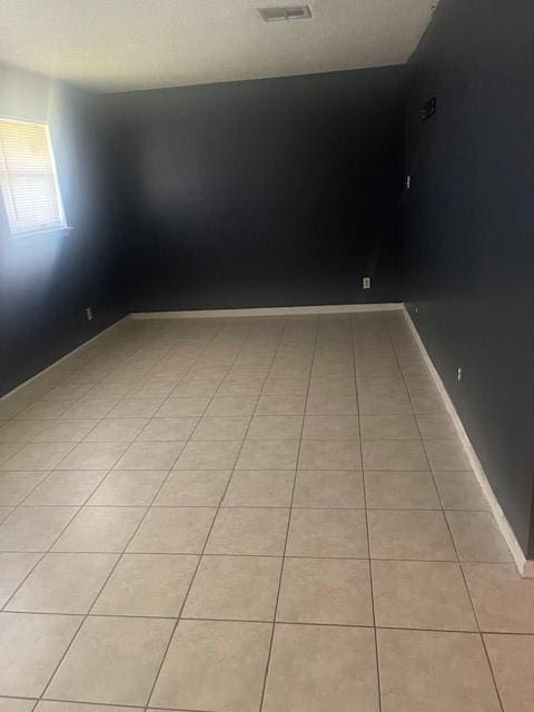 empty room featuring light tile patterned floors