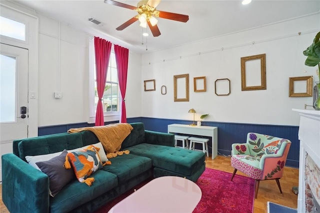 living room with ceiling fan and parquet flooring