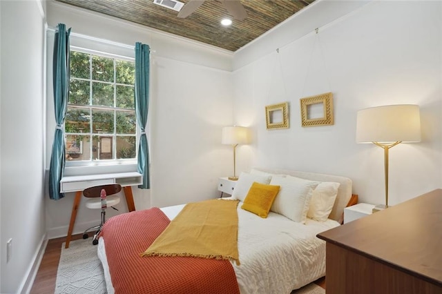 bedroom featuring wooden ceiling, ornamental molding, and hardwood / wood-style flooring