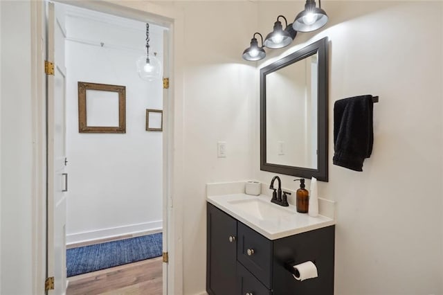 bathroom with hardwood / wood-style floors and vanity