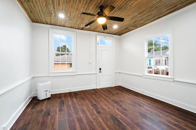 unfurnished room featuring crown molding, ceiling fan, dark wood-type flooring, and wood ceiling