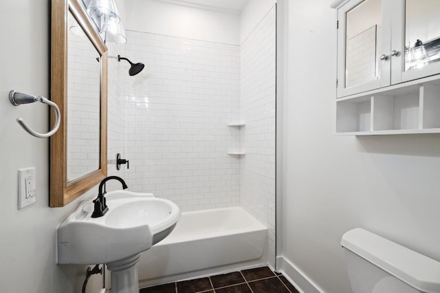 full bathroom with tile patterned floors, sink, tiled shower / bath, and toilet