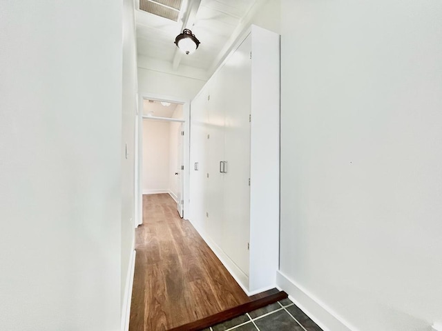 hall featuring dark tile patterned floors