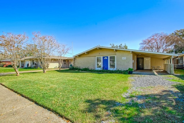 single story home featuring a front lawn and a carport