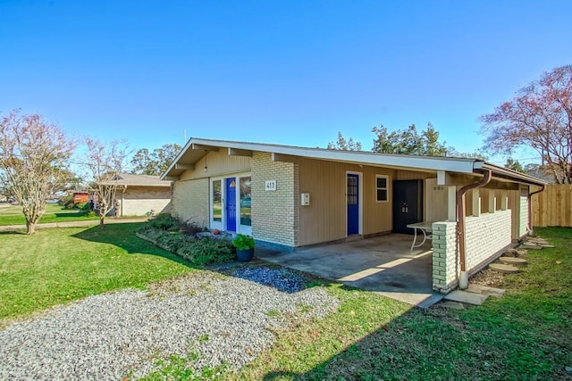 view of front facade with a front yard and a carport