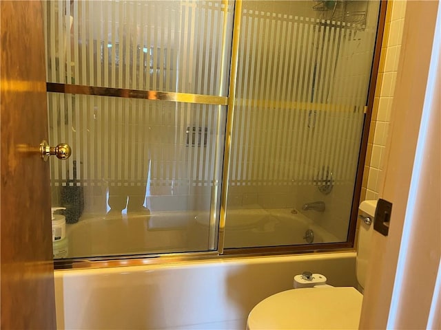 bathroom featuring shower / bath combination with glass door and toilet