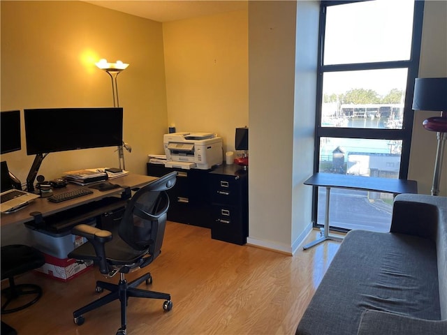 home office with light hardwood / wood-style floors