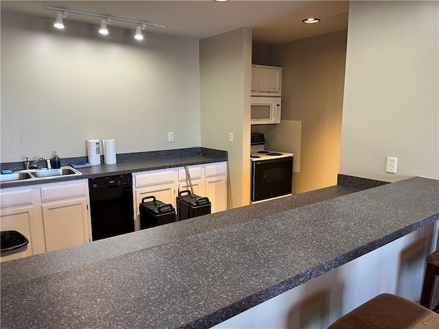 kitchen featuring a breakfast bar area, white cabinetry, sink, and white appliances