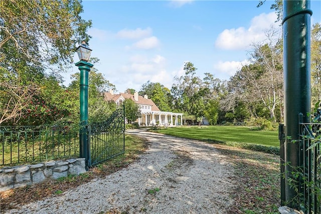 view of gate featuring a yard