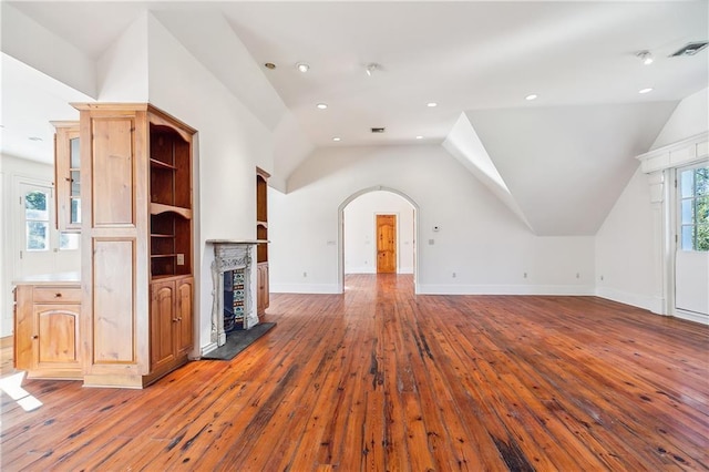 unfurnished living room with vaulted ceiling and hardwood / wood-style flooring