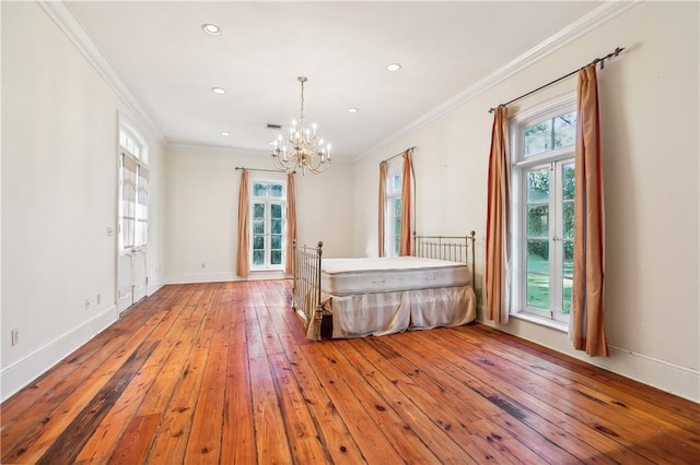 unfurnished bedroom with light hardwood / wood-style floors, an inviting chandelier, multiple windows, and crown molding