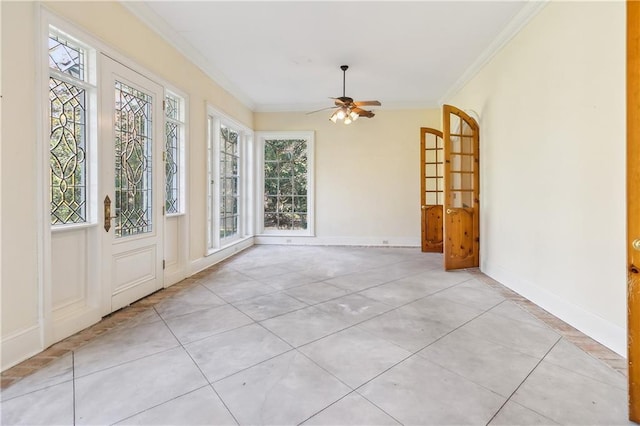 unfurnished room with ceiling fan, light tile patterned floors, and crown molding