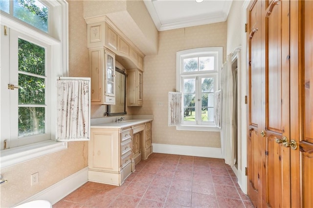 interior space featuring sink, light tile patterned floors, french doors, and ornamental molding