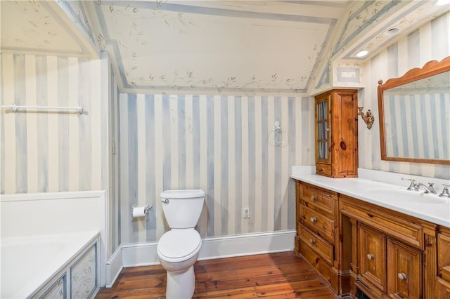 bathroom featuring hardwood / wood-style flooring, vanity, and toilet