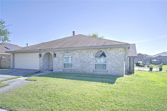 ranch-style home featuring a garage and a front lawn