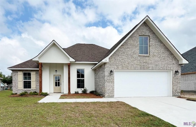 113 Olivia Dr, Luling, LA 70070 - view of front of property featuring stucco siding, roof with shingles, an attached garage, driveway, and a front yard