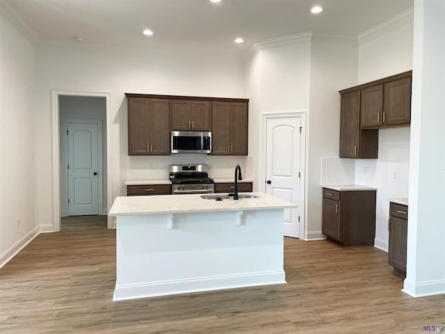 113 Olivia Dr, Luling, LA 70070 - kitchen with decorative backsplash, a sink, stainless steel appliances, and light wood-type flooring