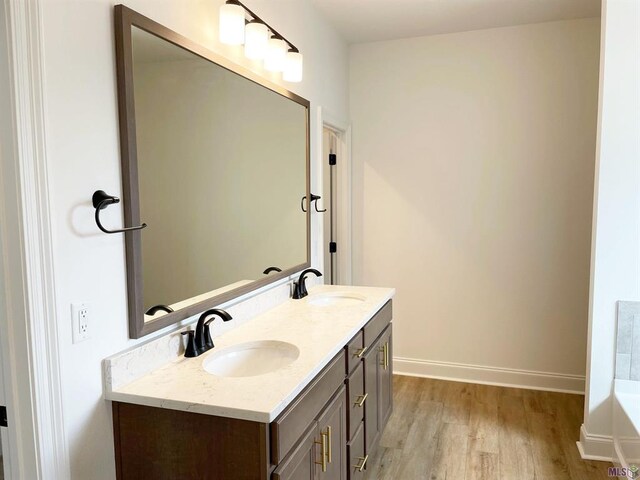 113 Olivia Dr, Luling, LA 70070 - full bathroom featuring double vanity, a sink, baseboards, and wood finished floors