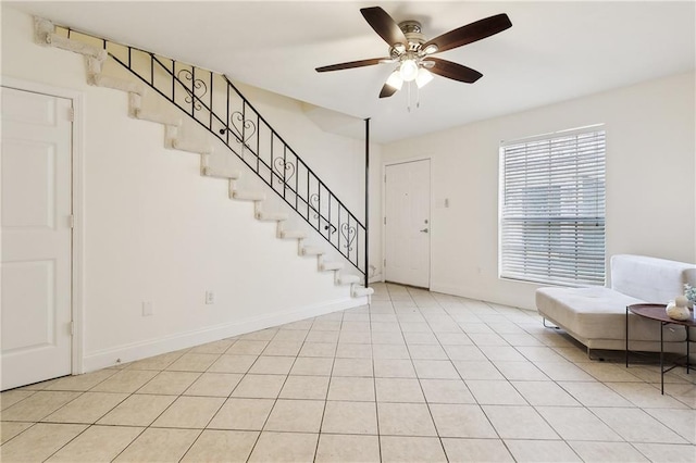 foyer entrance with light tile patterned floors and ceiling fan