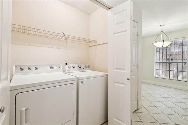 laundry area with light tile patterned floors and washer and dryer