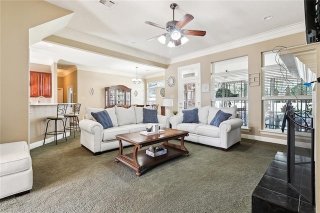 carpeted living room with ceiling fan with notable chandelier and ornamental molding