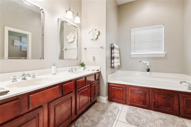 bathroom featuring tile patterned floors, vanity, and a tub to relax in